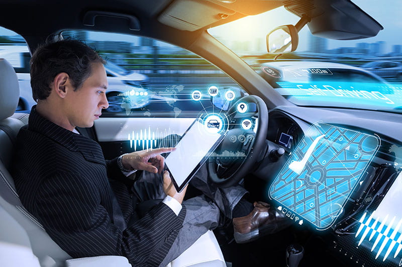 Man reading tablet in self-driving vehicle